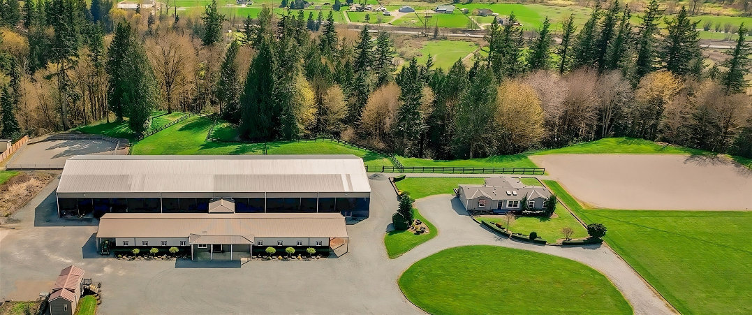 Aerial view of Seven Hills Training arenas, barns and turnout spaces